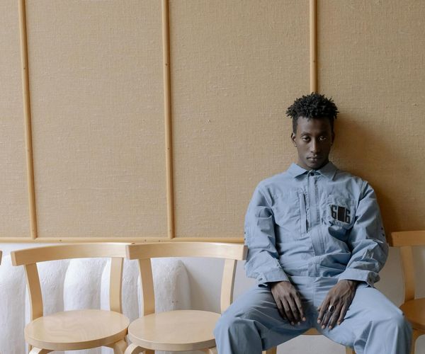 Person meditating peacefully in a calm, modern environment.